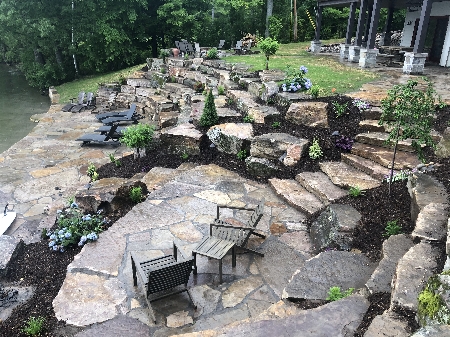 Upper and Lower Flagstone Patios with Boulder Terraces and Gardens